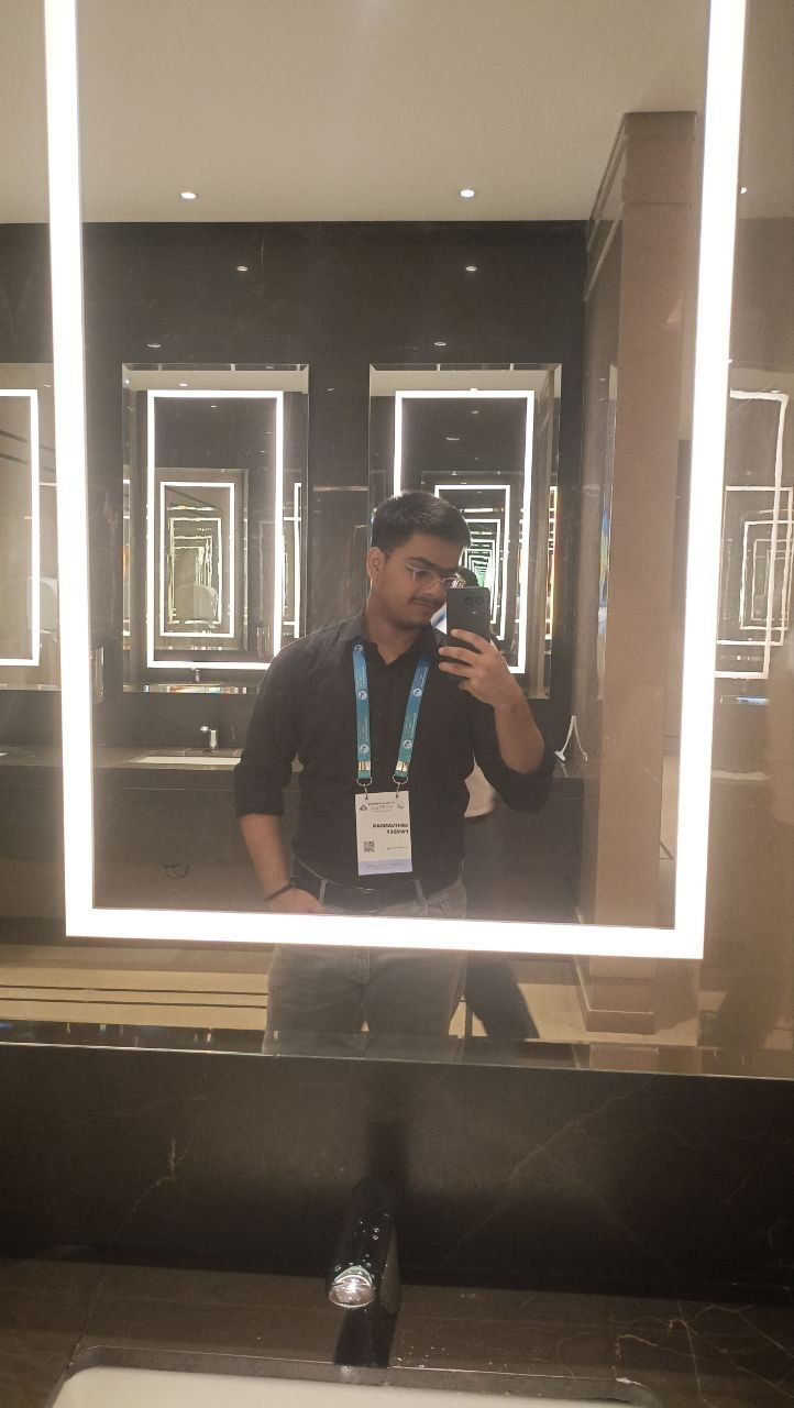 Mirror photo in a conference venue, event badge around the neck