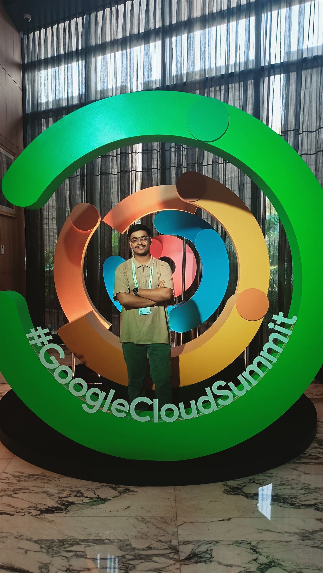 Abhinandan with arms crossed inside the Google Cloud Summit ring installation