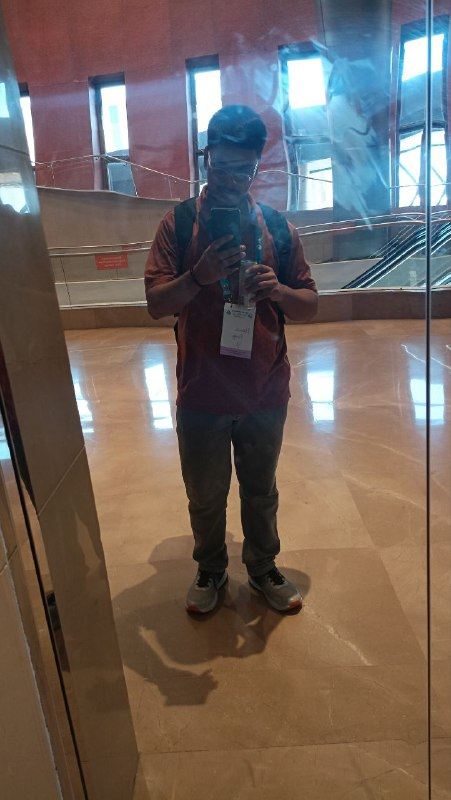 Mirror photo between conference sessions, lanyard and backpack still on